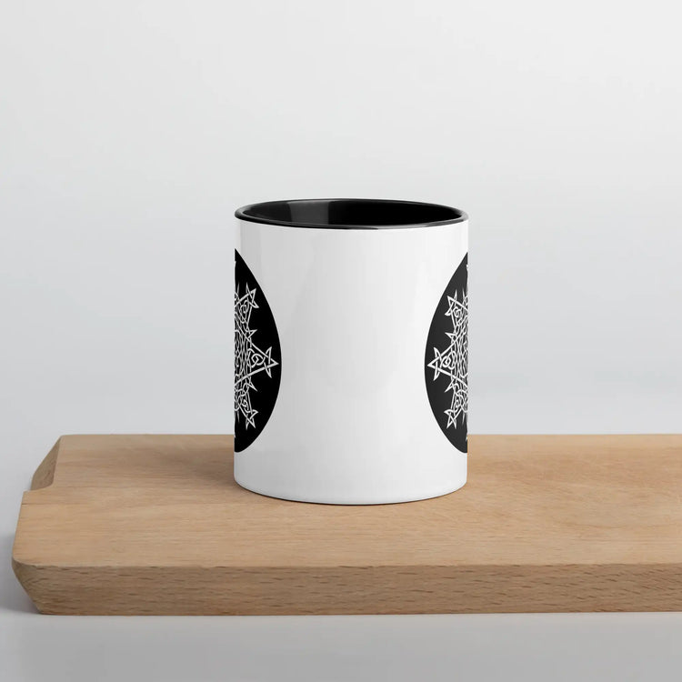 A Xigfireon white ceramic 11oz mug featuring the Black & White Circle iteration of the Morning Star Fire Celtic knot design, with black handle and inside. This Celtic knot symbolizes Father Sun.