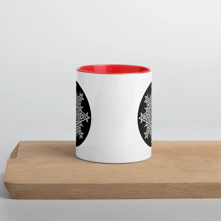 A Xigfireon white ceramic 11oz mug featuring the Black & White Circle iteration of the Morning Star Fire Celtic knot design, with red handle and inside. This Celtic knot symbolizes Father Sun.