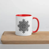 A cutting board displaying a Xigfireon white ceramic 11oz mug featuring the Black & White Solid iteration of the Morning Star Fire Celtic knot design, with red handle and inside. This Celtic knot symbolizes Father Sun.