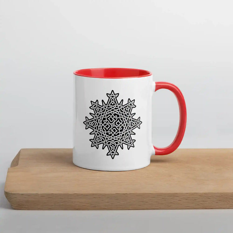 A cutting board displaying a Xigfireon white ceramic 11oz mug featuring the Black & White Solid iteration of the Morning Star Fire Celtic knot design, with red handle and inside. This Celtic knot symbolizes Father Sun.