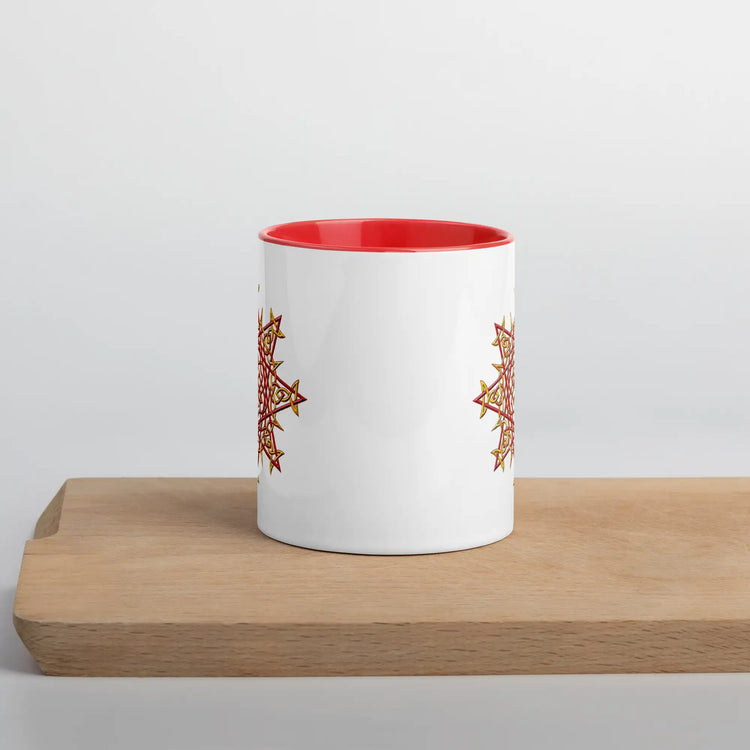 The front side of a Xigfireon white ceramic 11oz mug featuring the Fire Colour iteration of the Morning Star Fire Celtic knot design, with red handle and inside. This Celtic knot symbolizes Father Sun.