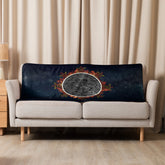 A sofa covered by a 37 inch by 57 inch Xigfireon sublimated sherpa blanket featuring the Eclipsed iteration of the Morning Star Fire Celtic knot design. Inspired by the 2023 Annular Solar Eclipse.