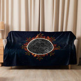 A sofa covered by a 60 inch by 80 inch Xigfireon sublimated sherpa blanket featuring the Eclipsed iteration of the Morning Star Fire Celtic knot design. Inspired by the 2023 Annular Solar Eclipse.