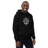 A young man wearing a black Xigfireon graphic eco hoodie featuring the Black & White Circle iteration of the Morning Star Fire Celtic knot design. The Morning Star Fire Celtic knot symbolizes the Sun.