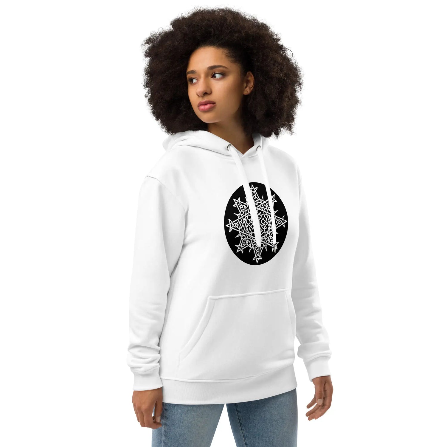 A young woman wearing a white Xigfireon graphic eco hoodie featuring the Black & White Circle iteration of the Morning Star Fire Celtic knot design. The Morning Star Fire Celtic knot symbolizes the Sun.