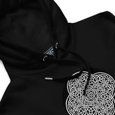 A close-up view of a black Xigfireon graphic eco hoodie featuring the Black & White Circle iteration of the Reach Of The Spirit Celtic knot design. The Reach Of The Spirit Celtic knot represents our glorious Mother Earth.