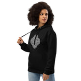 A young woman wearing a black Xigfireon graphic eco hoodie featuring the Black & White Solid iteration of the Reach Of The Spirit Celtic knot design. The Reach Of The Spirit Celtic knot symbolizes our magnificent Mother Earth.
