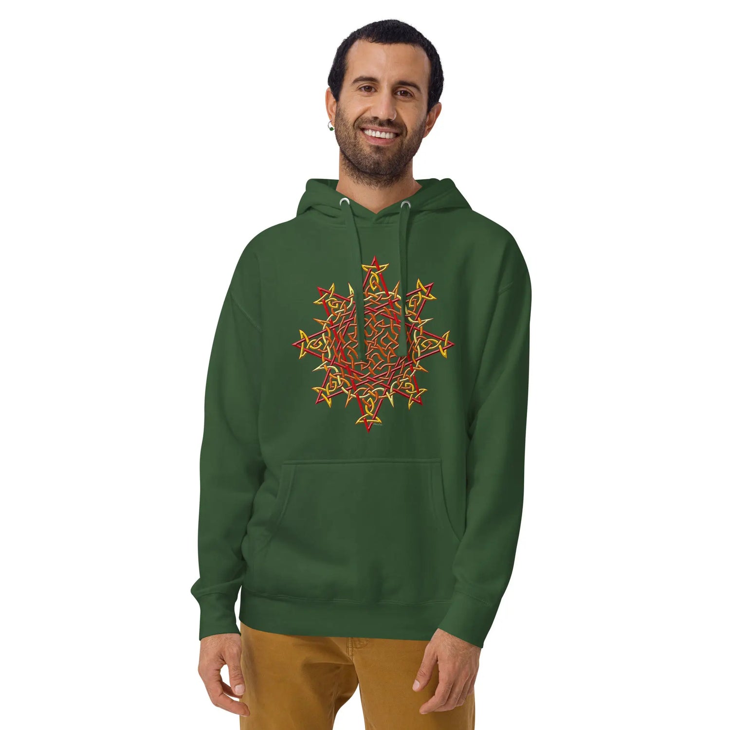 A young man wearing a forest green Xigfireon graphic hoodie featuring the Fire Colour iteration of the Morning Star Fire Celtic knot design. The Morning Star Fire Celtic knot represents the Sun.