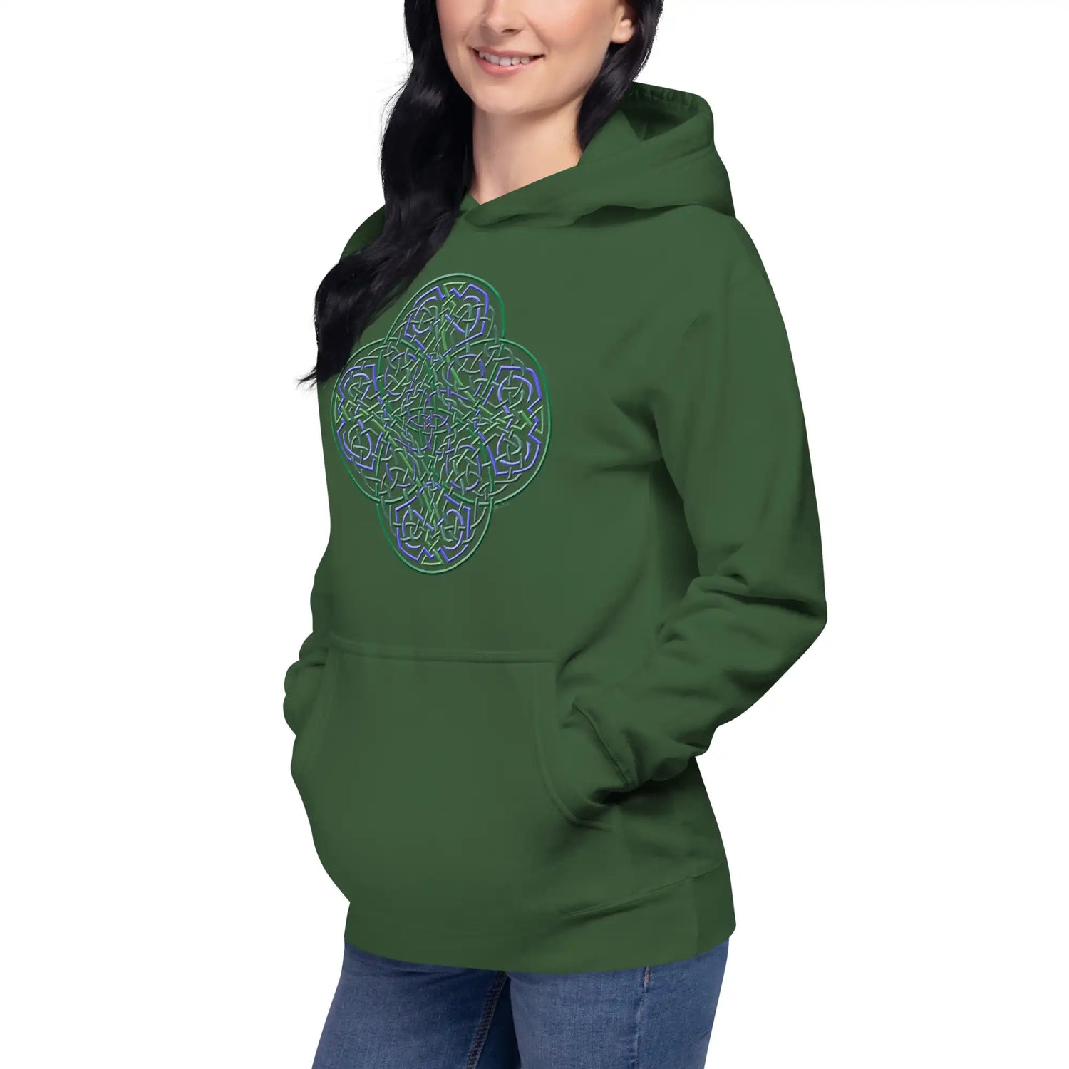 A young woman wearing a forest green Xigfireon graphic hoodie featuring the Living Colour iteration of the Reach Of The Spirit Celtic knot design. The Reach Of The Spirit Celtic knot symbolizes our wonderful Mother Earth.