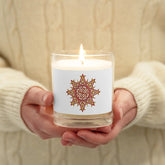 A persons hands holding a Xigfireon glass jar soy wax candle featuring the Fire Colour iteration of the Morning Star Fire Celtic knot design. The Morning Star Fire Celtic knot symbolizes Father Sun.