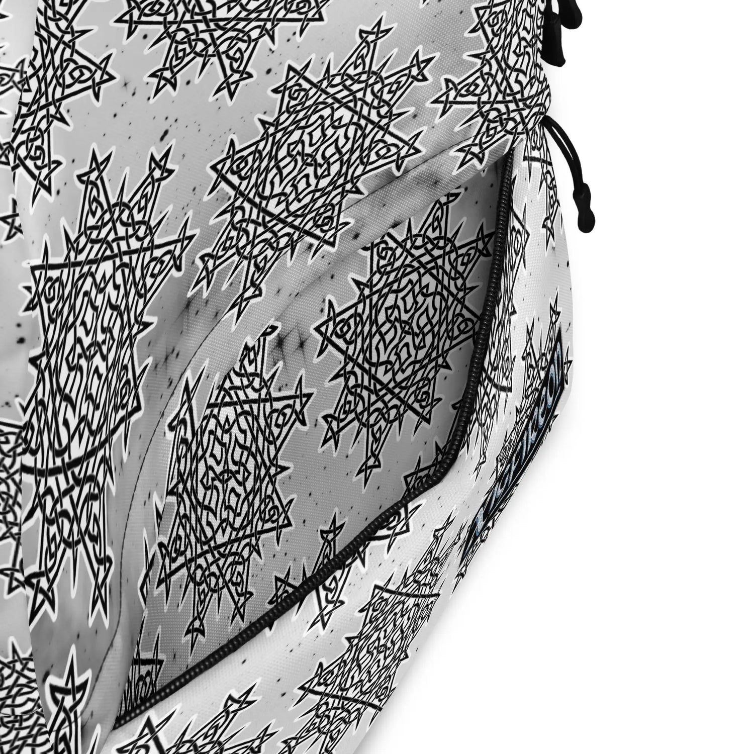A view of the inside pocket of a Xigfireon graphic backpack featuring the Black & White Solid Cosmos Inverted iteration of the `Morning Star Fire` Celtic knot pattern.