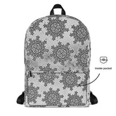A view of the back of a Xigfireon graphic backpack featuring the Black & White Solid Cosmos Inverted iteration of the `Morning Star Fire` Celtic knot pattern. A simple graphic and arrow indicate the location of the inside pocket.