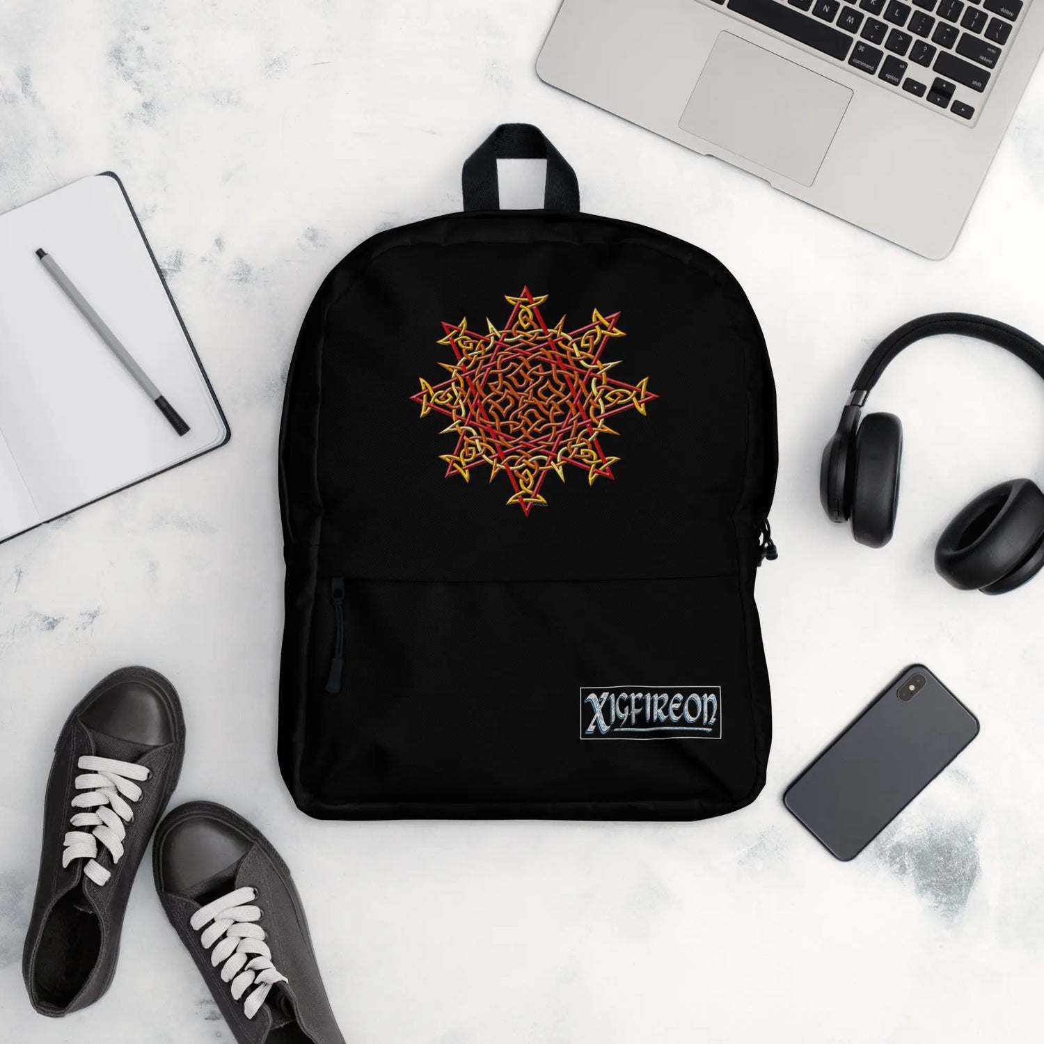 A view of a few new school year essentials, including a Xigfireon graphic backpack featuring the Fire Colour iteration of the `Morning Star Fire` Celtic knot design.