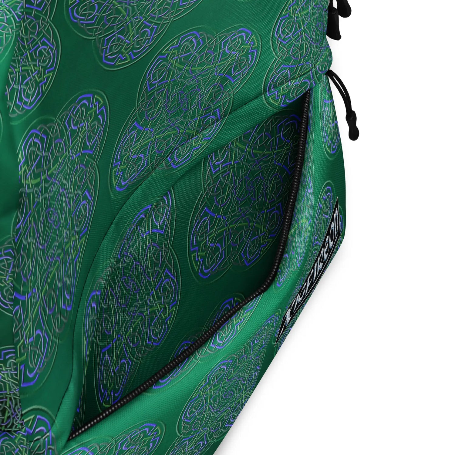 A view of the inside pocket of a Xigfireon graphic backpack featuring the Living Colour Forest Inverted iteration of the `Reach Of The Spirit` Celtic knot pattern.