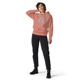 A young woman wearing a dusty rose Xigfireon graphic hoodie featuring the Black & White Hollow iteration of the Morning Star Fire Celtic knot design. This Celtic knot symbolizes the Sun.