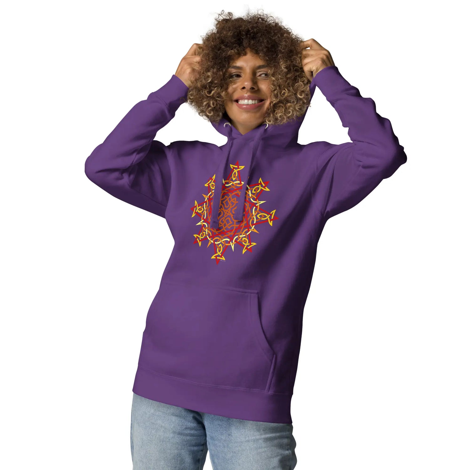 A young woman wearing a purple Xigfireon graphic hoodie featuring the Fire Colour Flat iteration of the Morning Star Fire Celtic knot design. The Morning Star Fire Celtic knot represents our brilliant Father Sun.