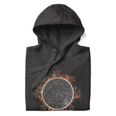 A folded charcoal heather grey Xigfireon graphic hoodie featuring the Eclipsed iteration of the Morning Star Fire Celtic knot design, inspired by the 2023 Annular Solar Eclipse.