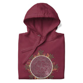 A folded maroon Xigfireon graphic hoodie featuring the Eclipsed iteration of the Morning Star Fire Celtic knot design, inspired by the 2023 Annular Solar Eclipse.