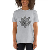 A young woman wearing a sport grey Xigfireon graphic t-shirt featuring the Black & White Solid iteration of the Morning Star Fire Celtic knot design. The Morning Star Fire Celtic knot represents Father Sun and the eternal Cosmic Light.
