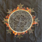 A close-up view of a classic black Xigfireon graphic tee featuring the Eclipsed iteration of the Morning Star Fire Celtic knot design, inspired by the Annular Solar Eclipse of 2023.