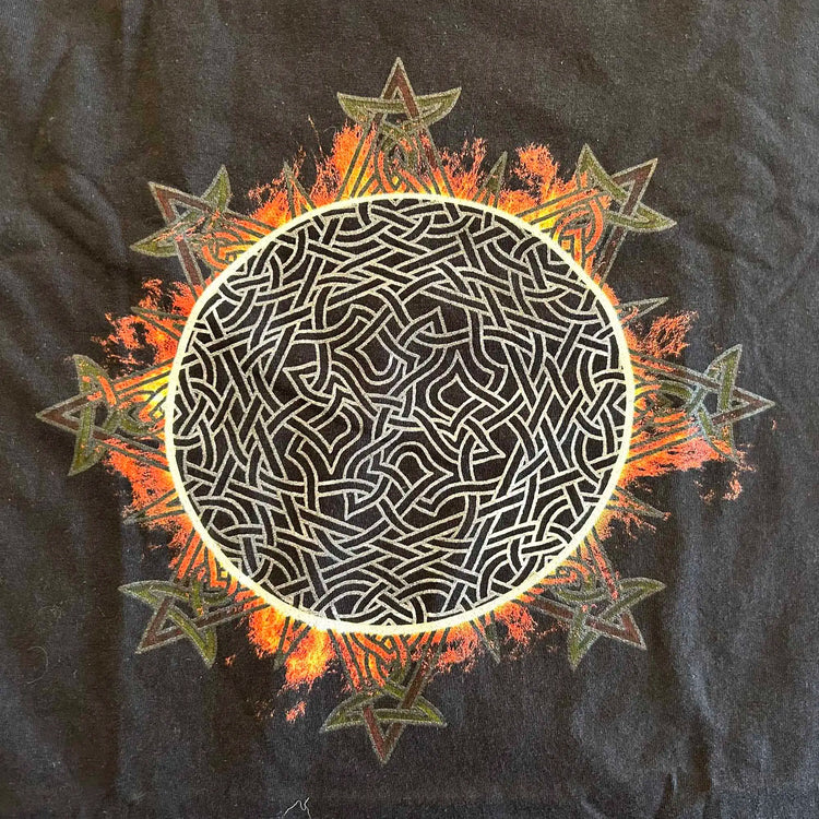 A close-up view of a classic black Xigfireon graphic tee featuring the Eclipsed iteration of the Morning Star Fire Celtic knot design, inspired by the Annular Solar Eclipse of 2023.