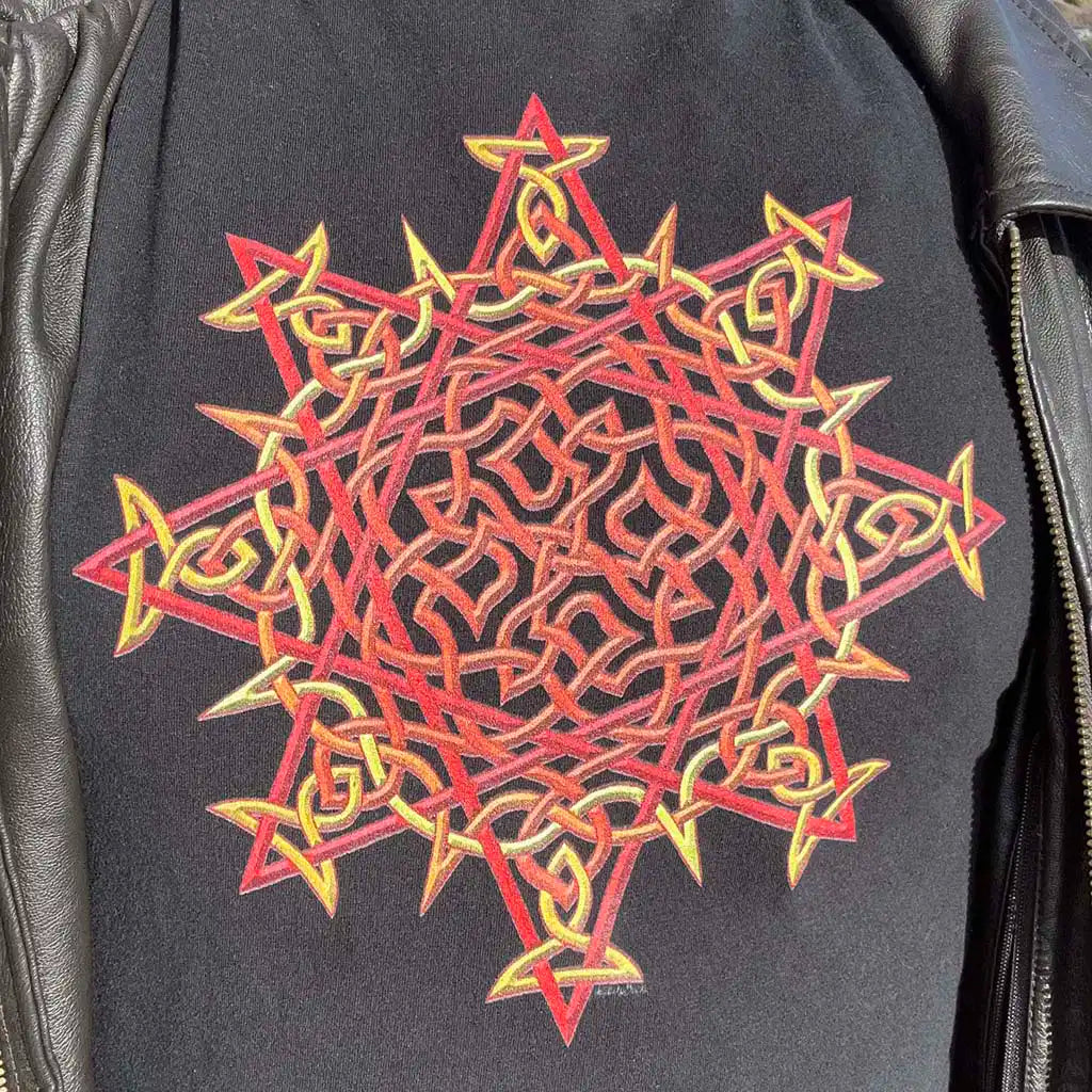 The Morning Star Fire Celtic knot design in the original blazing Fire Colour on a black graphic t-shirt worn with a brown leather zip-up jacket.