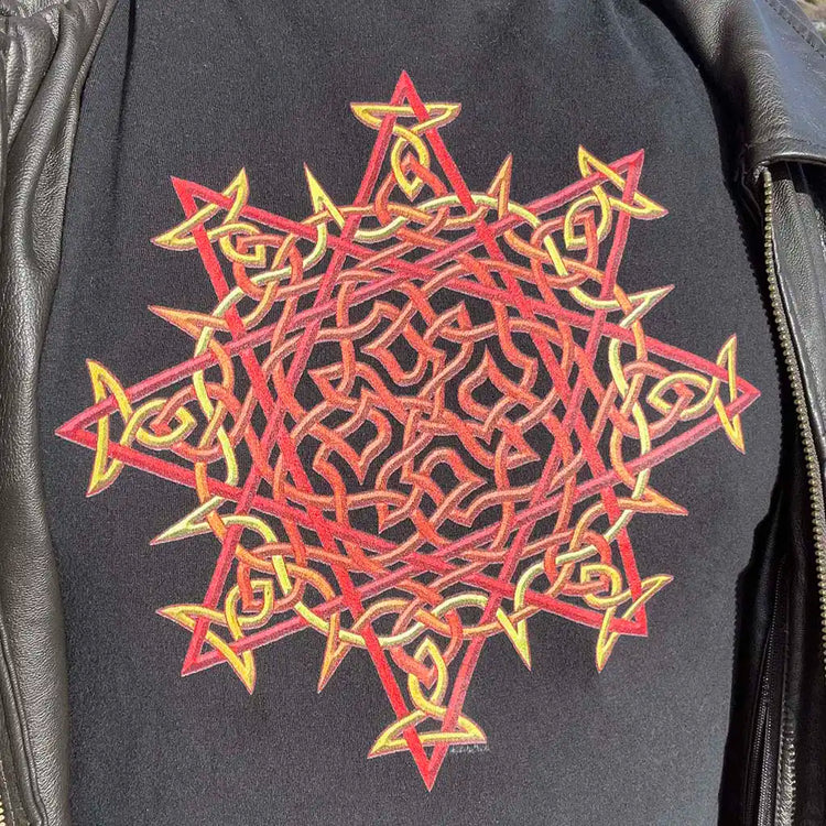 The Morning Star Fire Celtic knot design in the original blazing Fire Colour on a black graphic t-shirt worn with a brown leather zip-up jacket.