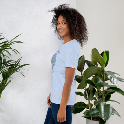 A young woman wearing a baby blue Xigfireon graphic t-shirt featuring the Living Colour iteration of the Reach Of The Spirit Celtic knot design along with a message in a Celtic font: "Our Mother, Cherish Her".