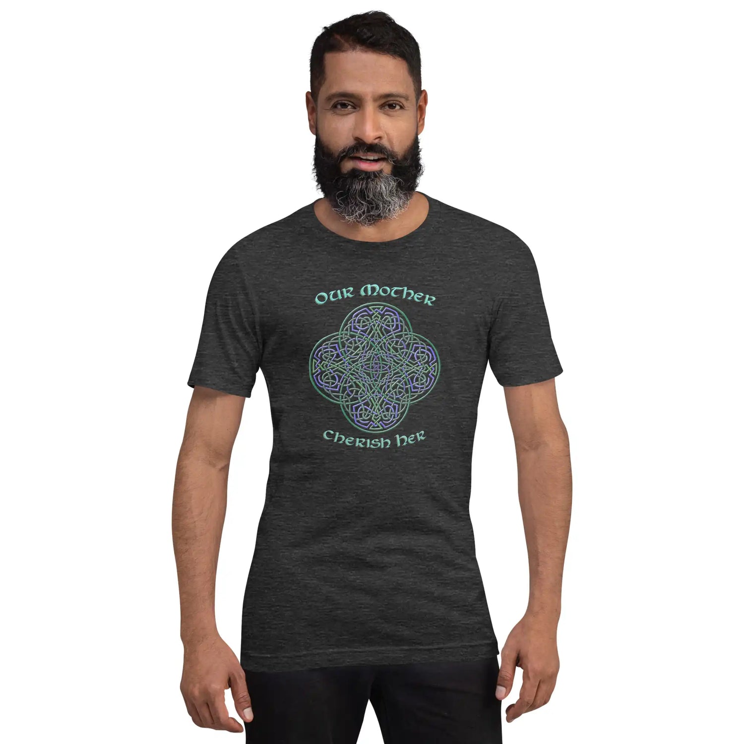 A young man wearing a dark grey heather graphic t-shirt featuring the Living Colour iteration of the Reach Of The Spirit Celtic knot design along with a message in a Celtic font: "Our Mother, Cherish Her".