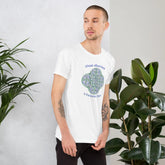 A young man wearing a white Xigfireon graphic t-shirt featuring the Living Colour iteration of the `Reach Of The Spirit` Celtic knot design along with a message in a Celtic font: "Our Mother, Cherish Her".