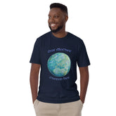 A young man wearing a navy blue Xigfireon graphic t-shirt featuring the Sacred Planet iteration of the `Reach Of The Spirit` Celtic knot design along with a message in a Celtic font: "Our Mother, Cherish Her".