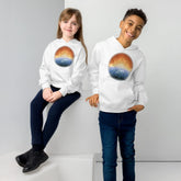 A girl and a boy, each wearing a white graphic hoodie featuring the Derivation II Celtic knots merger design.