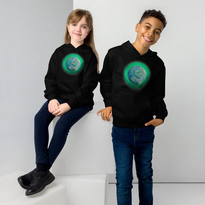 A young girl and a young boy, each wearing a black graphic hoodie featuring the Deep Forest iteration of the Reach Of The Spirit Celtic knot design.