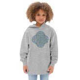 A young girl wearing a kids athletic heather graphic hoodie featuring the Living Colour iteration of the Reach Of The Spirit Celtic knot design.
