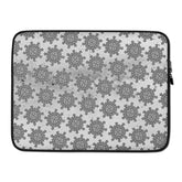A 15 inch graphic laptop sleeve featuring the Inverted Black & White Solid Cosmos iteration of the Morning Star Fire Celtic knot pattern.