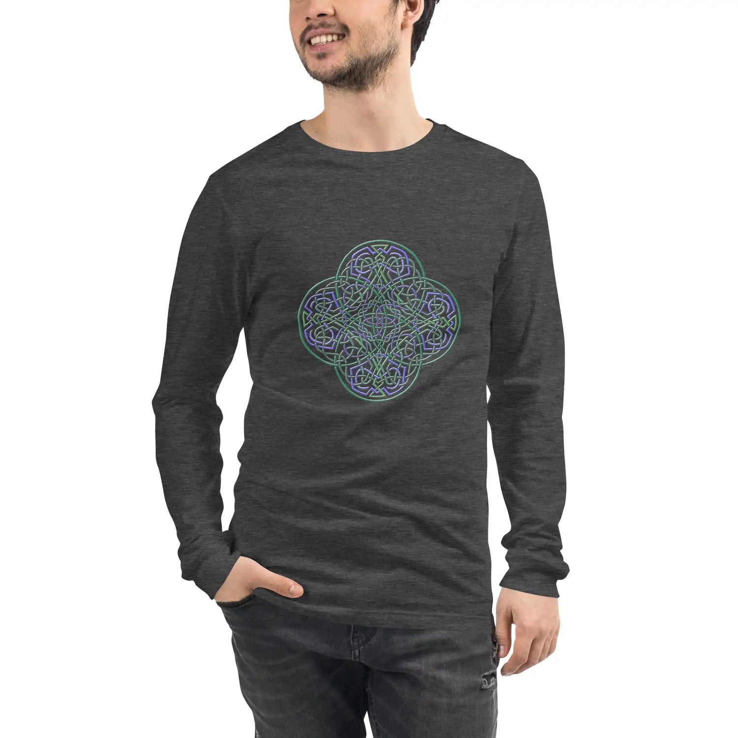 A young man wearing a dark grey heather Xigfireon long sleeve graphic t-shirt featuring the Living Colour iteration of the Reach Of The Spirit Celtic knot design. The Reach Of The Spirit Celtic knot symbolizes Mother Earth.