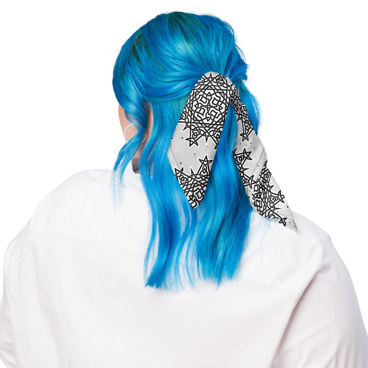 A young woman shown wearing a Xigfireon bandana adorned with the `Morning Star Fire` Black and White Solid Cosmos Inverted Celtic knot pattern.