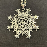 Necklace, up close, with a Morning Star Fire Celtic knot pendant in flat stainless steel by Xigfireon.