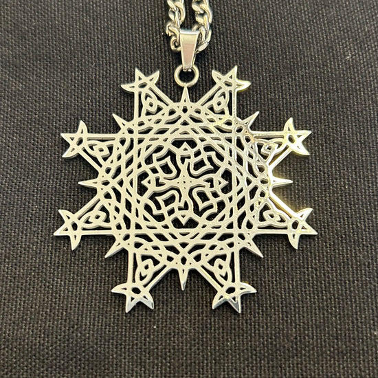Necklace, up close, with a Morning Star Fire Celtic knot pendant in flat stainless steel by Xigfireon.