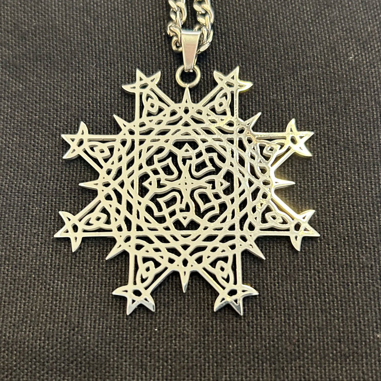 Necklace, up close, with a Morning Star Fire Celtic knot pendant in flat stainless steel by Xigfireon.