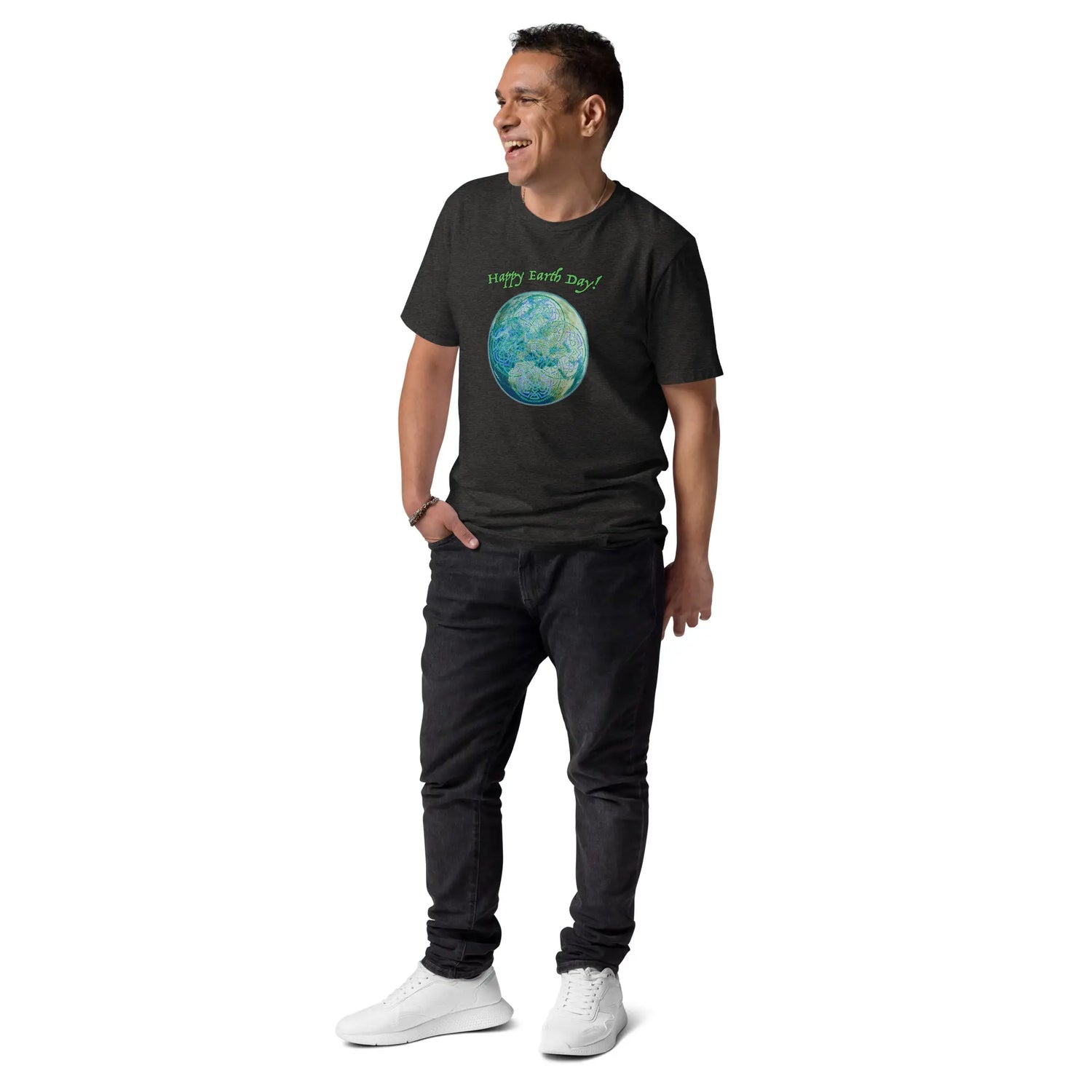 A young man wearing a dark heather grey organic graphic t-shirt featuring the Sacred Planet iteration of the Reach Of The Spirit Celtic knot design under a message reading "Happy Earth Day".