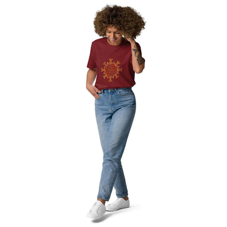 A young woman wearing a burgundy Xigfireon graphic organic cotton t-shirt featuring the Fire Colour iteration of the Morning Star Fire Celtic knot design. The Morning Star Fire Celtic knot represents our benevolent Father Sun.