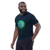 A young man wearing a French navy blue Xigfireon graphic organic cotton t-shirt featuring the Deep Forest iteration of the Reach Of The Spirit Celtic knot design. The Reach Of The Spirit Celtic knot represents the glorious Earth.