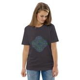 A young woman wearing an anthracite Xigfireon graphic organic cotton t-shirt featuring the Living Colour iteration of the Reach Of The Spirit Celtic knot design. The Reach Of The Spirit Celtic knot represents our amazing Mother Earth.