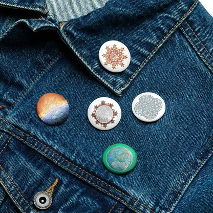 A jean jacket with 5 assorted 1.25 inch pin-back buttons featuring Morning Star Fire, Reach Of The Spirit, and Derivation II Celtic knot designs.