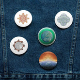 A jean jacket with 5 assorted 2.25 inch pin-back buttons featuring Morning Star Fire, Reach Of The Spirit, and Derivation II Celtic knot designs.