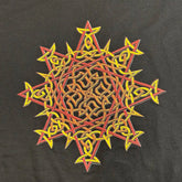 A close-up view of a black Xigfireon graphic t-shirt featuring a screen printed version of the Fire Colour iteration of the `Morning Star Fire` Celtic knot design.