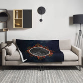 A sofa covered by a 50 inch by 60 inch Xigfireon throw blanket featuring the Eclipsed iteration of the Morning Star Fire Celtic knot design. Inspired by the 2023 Annular Solar Eclipse.