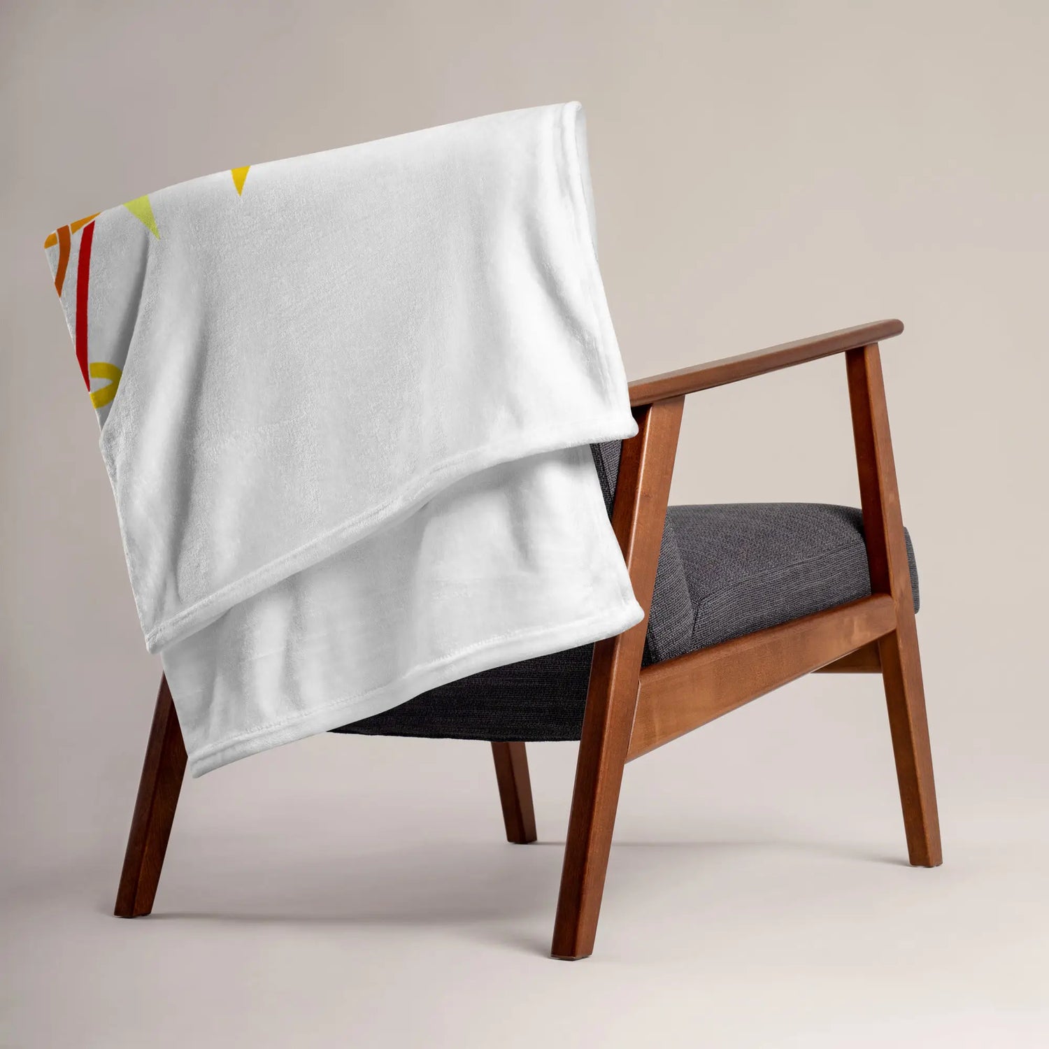 A chair covered by a 50 inch by 60 inch Xigfireon throw blanket featuring the Fire Colour Flat iteration of the Morning Star Fire Celtic knot design. The Morning Star Fire Celtic knot represents the Sun.