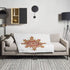 A sofa covered by a 50 inch by 60 inch Xigfireon throw blanket featuring the Fire Colour iteration of the Morning Star Fire Celtic knot design. The Morning Star Fire Celtic knot represents the Sun.